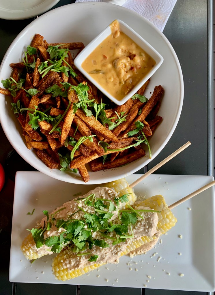 Mexican street corn and a bowl of french fries