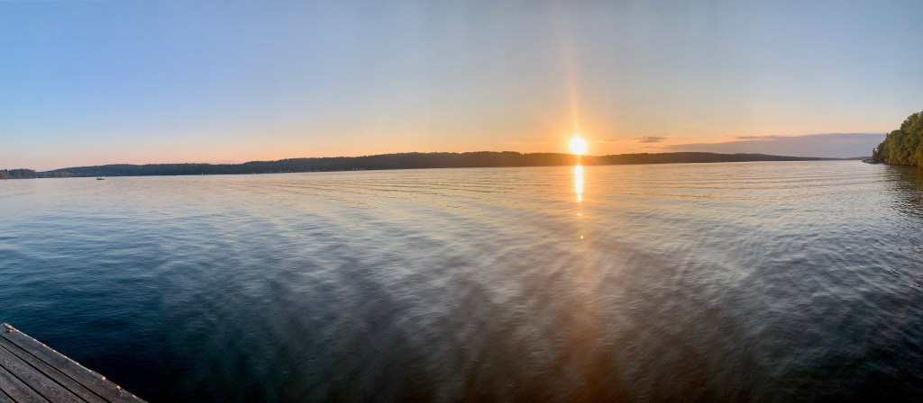 Calm lake with sun setting in the background