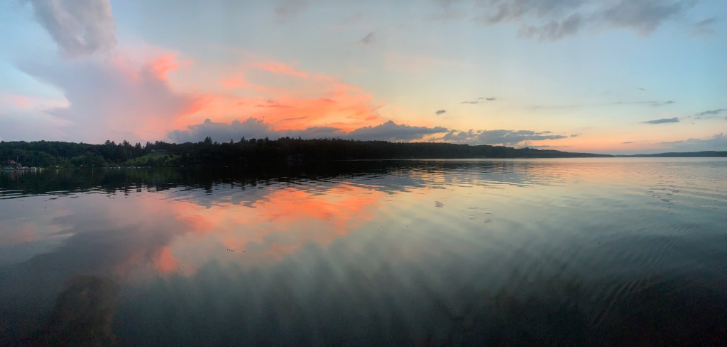 Calm lake with sun setting in the background