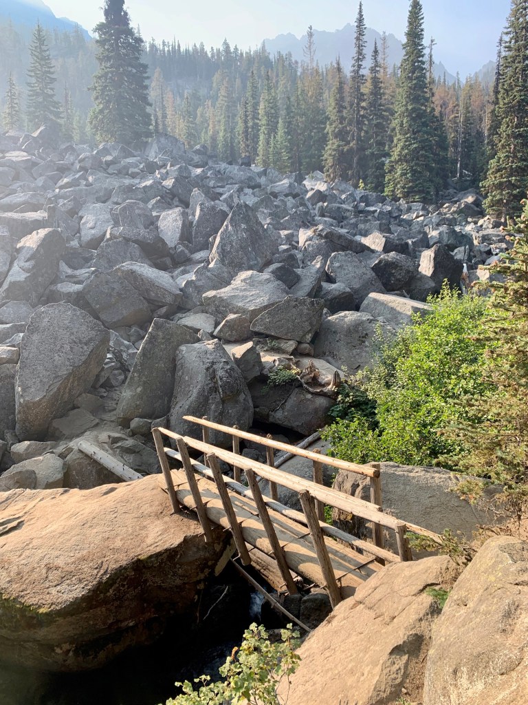 man-made bridge on a trail surrounded by rocks
