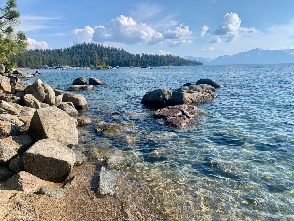 Clear lake water with rocky shoreline